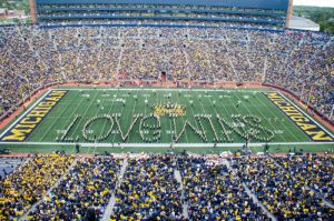 Michigan Stadium during the Spectrum 50th halftime show. The band spells out 'Love Wins'